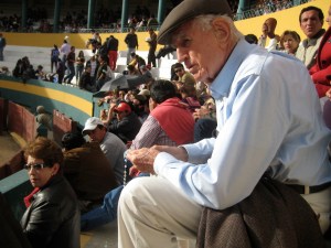 My Grandfather prays the rosary for his son before a bullfight.