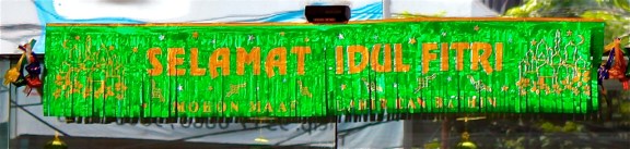  This sign on the door of a Honda dealership reads "Happy Idul Fitri... Forgive my physical and emotional (wrongdoings)".  Other sale signs suggest they still hope you will buy a Honda.