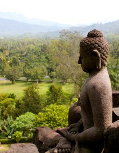 A statue of the Buddha looks out over Borobudur, central Java. 