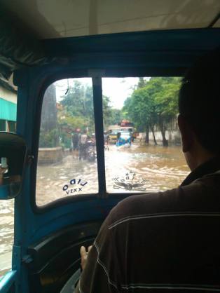 The driver of this motorcycle- taxi asked my co-worker to get out and walk because the water was too deep. (Photo: Juairia Sitabutar)