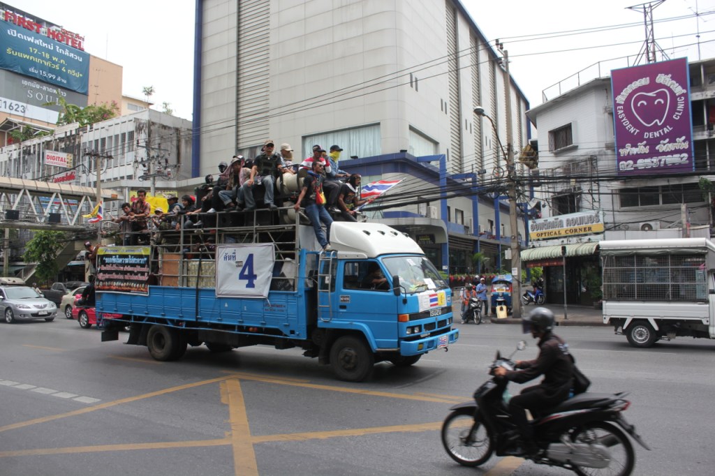 A truck full of protesters barrels through the streets of Bangkok a few days before the military coup in Thailand.